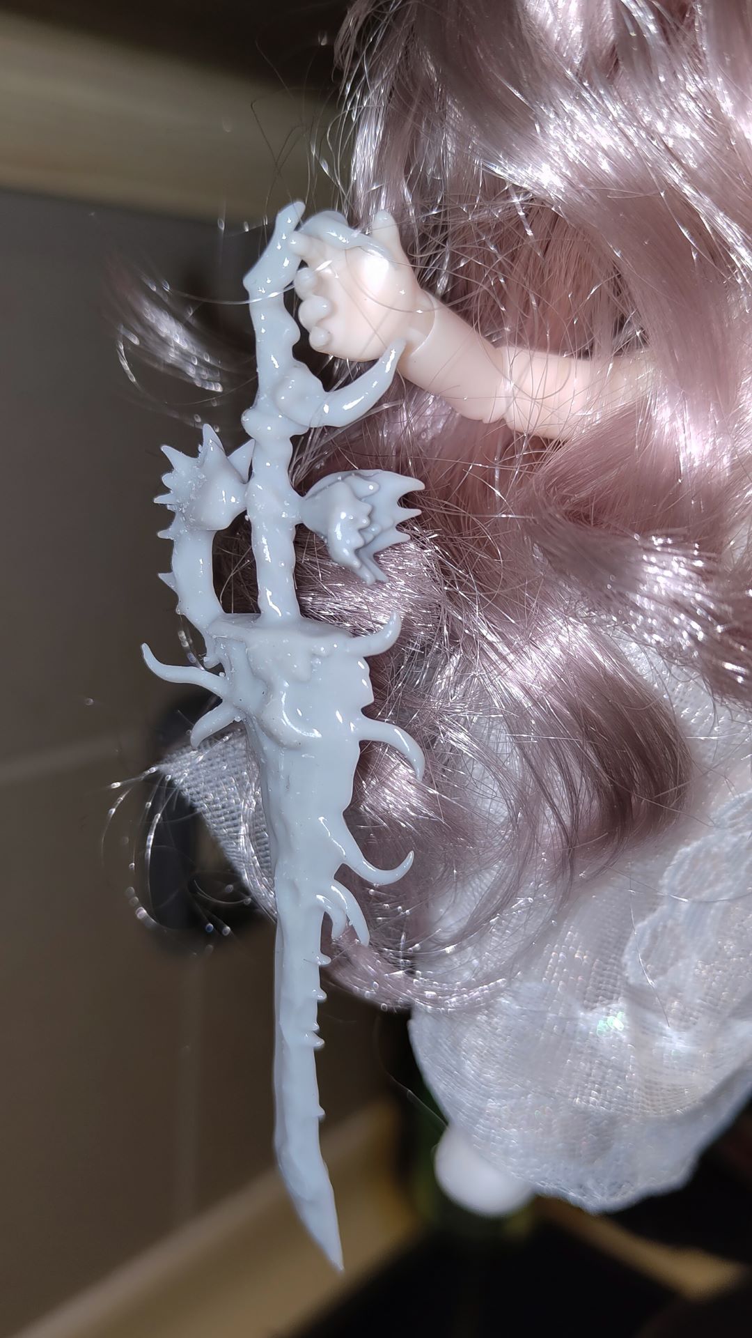 close up of the 3d printed sword on the right hand of the doll